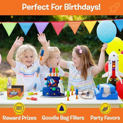 Full set of twenty-four assorted color jumping rubber popper toys arranged neatly for party favors.