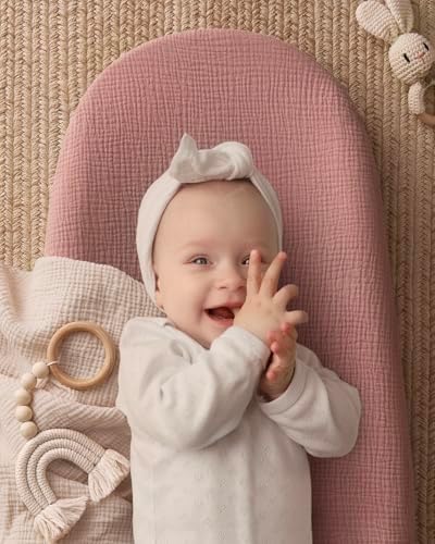 Dusty pink and avocado print baby changing pad on dresser