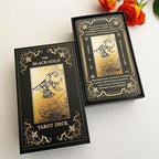 Arrangement of black and gold tarot cards on table