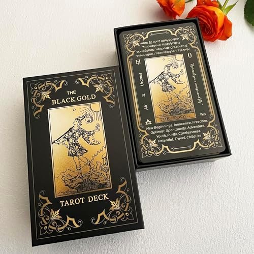 Arrangement of black and gold tarot cards on table