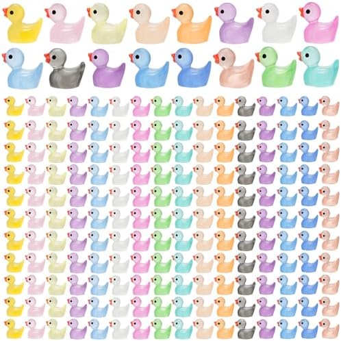 Assorted colorful miniature glow in the dark ducks arranged by color shade