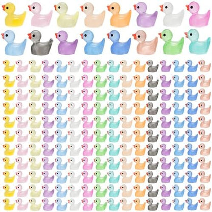 Assorted colorful miniature glow in the dark ducks arranged by color shade