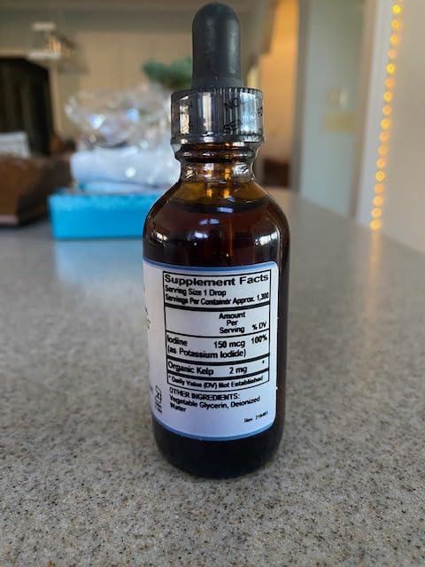 Two fluid ounce bottle of pure mountain botanicals metabolism support drops on clean background.