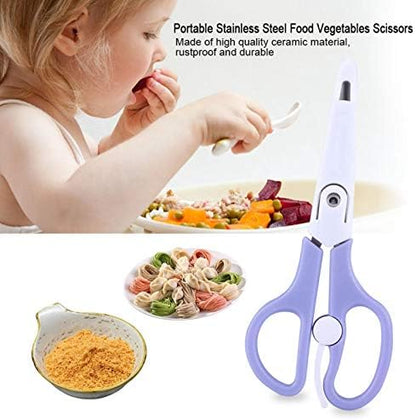 Portable infant food cutter slicing through cooked noodles in a bowl