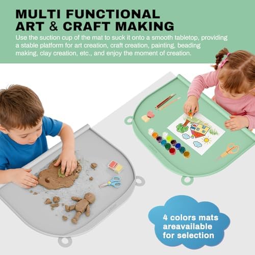 Toddler using the AUFORPET waterproof silicone mat during a messy arts and crafts painting session.