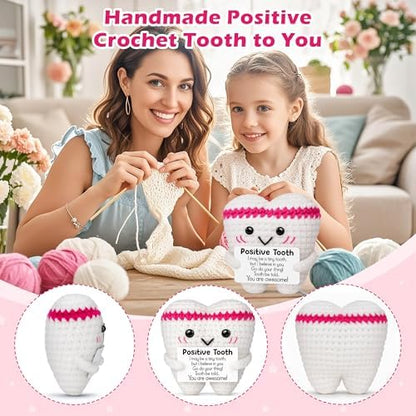 Positive crochet tooth plush held in hand for size reference
