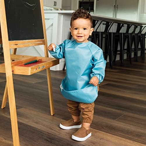 Side angle of Tiny Twinkle baby feeding smock highlighting the open flip out spill catcher pocket.