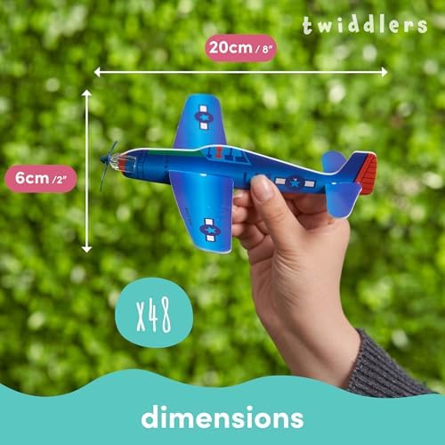 Children holding the assembled colorful paper toy planes ready for an outdoor flying game.