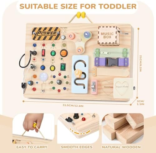 Toddler hands operating the hand-cranked music box and turning on the colorful LED lights.