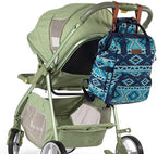 Wrangler travel backpack attached to stroller handles using integrated stroller straps