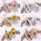 Assorted holographic nail foil transfer stickers rolls laid out.