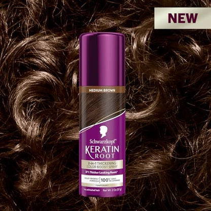 Person applying temporary root spray to gray hair roots
