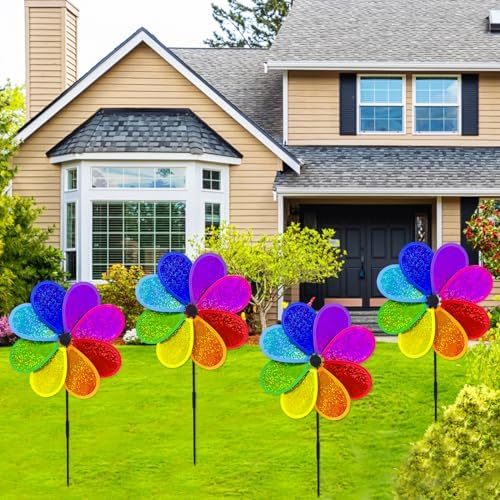 Four colorful garden windmills arranged in a lawn