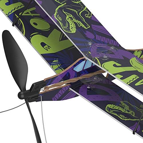 Teenager launching the assembled educational biplane toy in an outdoor park