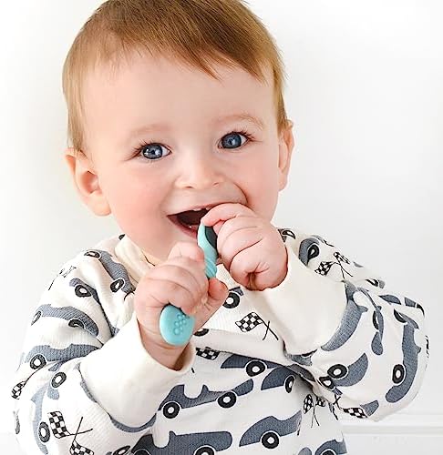 Infant holding the short non slip handle of the PrimaStella silicone spoon