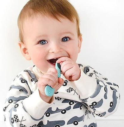 Infant holding the short non slip handle of the PrimaStella silicone spoon
