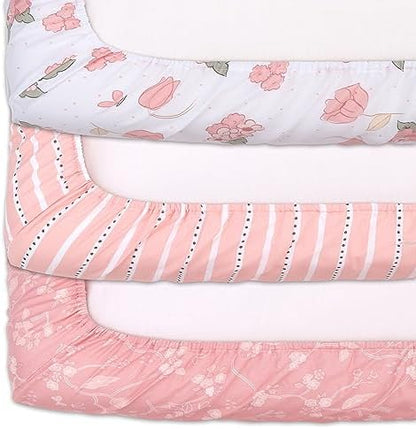 Three unique pink and white patterns included in the baby girl nursery bedding set