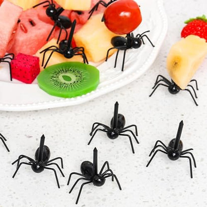 Close up of black plastic ant shaped dessert picks