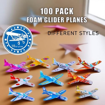 A massive collection of one hundred unboxed multi-colored mini paper airplane style foam gliders.