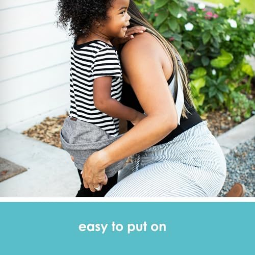 Adjustable toddler hip carrier with split padded shoulder strap worn by parent