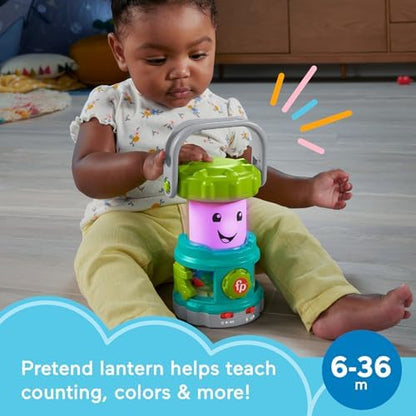 Infant playing with the light up educational lantern toy during indoor playtime.