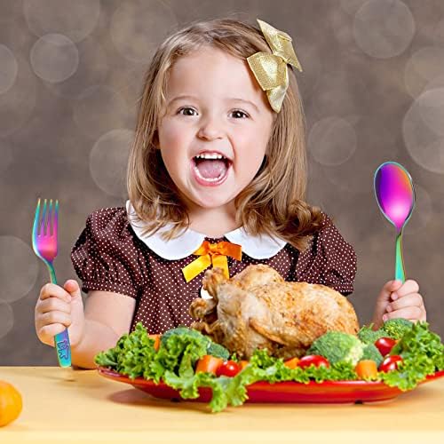 Small hands holding Pimoys rainbow stainless steel toddler fork