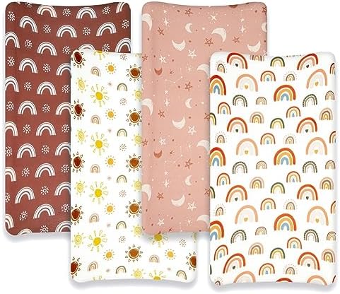 Close up view of the earthy rainbow and sunshine prints on the neutral baby fitted sheets.