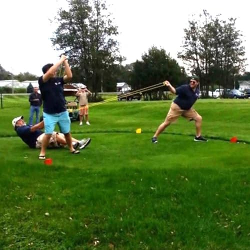 Three people demonstrating how to hold and pull back the giant outdoor slingshot catapult
