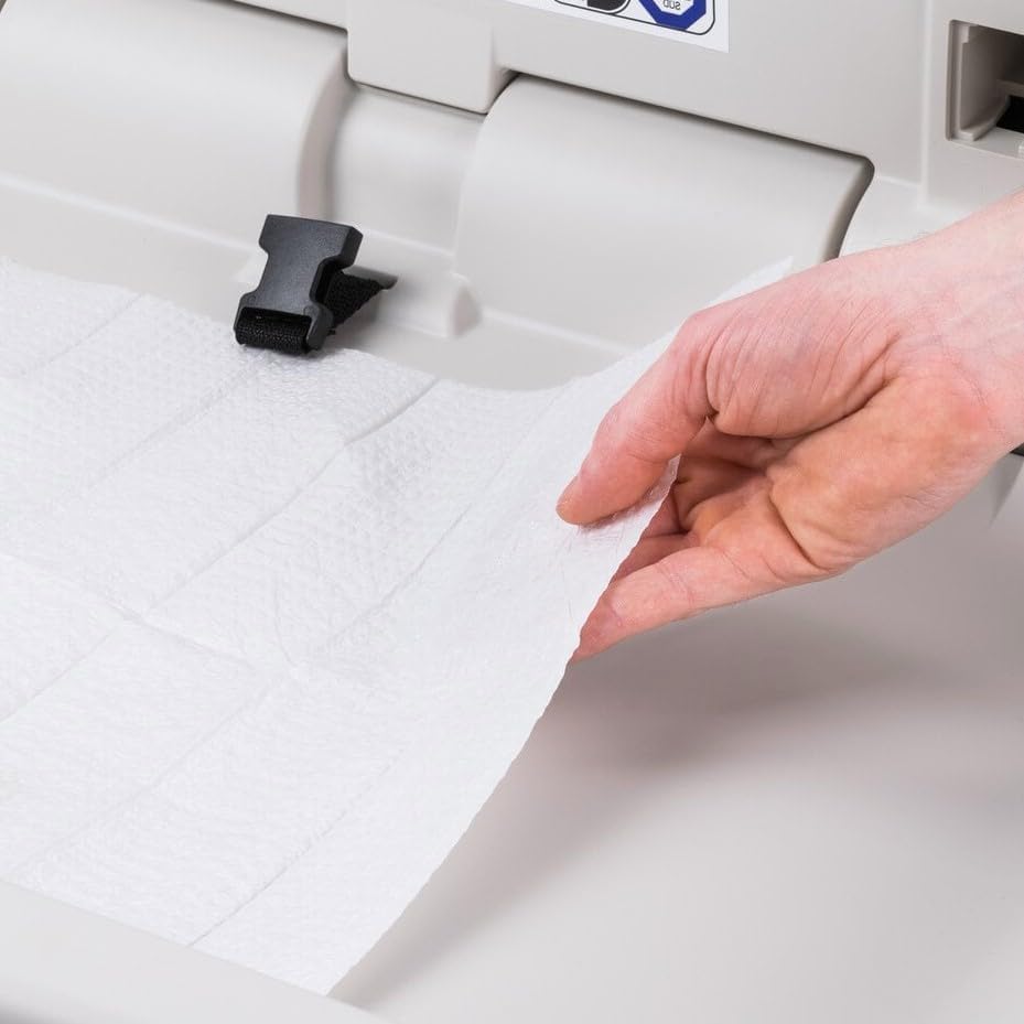 Stack of white 2-ply hygienic paper mats for commercial restrooms
