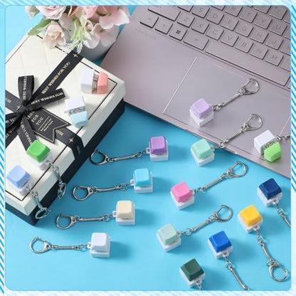A collection of multi colored Halloscume mechanical keycap toys showing the swappable cap variety.