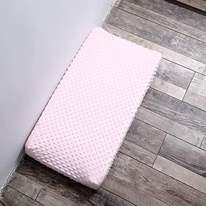 Lifestyle setup of the imported blushing bride pink changing pad sheet inside a modern nursery room.