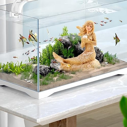 SwandTanpand mermaid statue sitting on aquarium sand