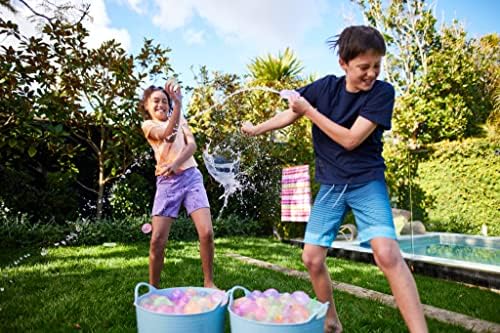 Bright tropical colored water balloons prepared and ready for a backyard summer party.