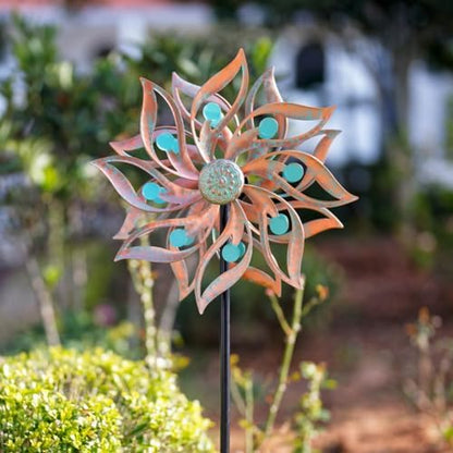 Kinetic wind sculpture showing the weatherproof bronze powder coat finish and detailed leaf shaped blades.