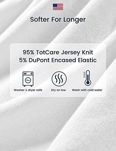 Two-pack of TotAha baby girl changing pad covers neatly folded on a nursery table