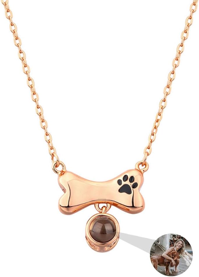 Close up of the polished copper dog bone charm with paw engraving.