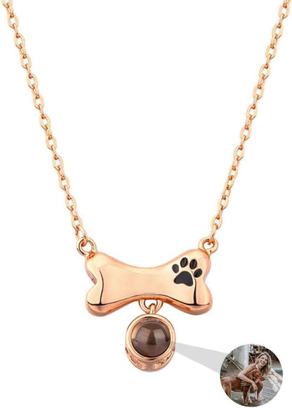 Close up of the polished copper dog bone charm with paw engraving.