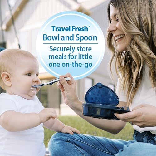 Dr. Brown's soft-tip baby spoon snapping into the designated storage slot on the lid.