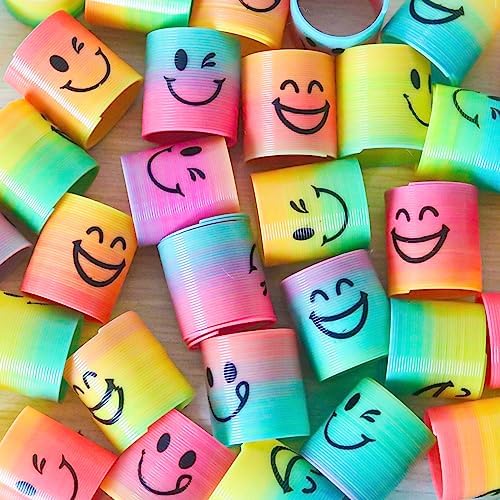 A collection of vibrant non toxic plastic mini springs spread out as decorative fillers for festive party tables.