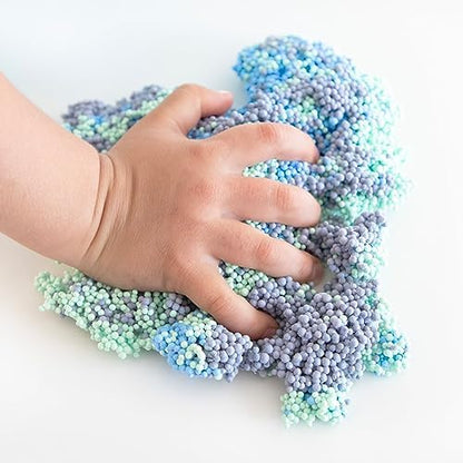 Adult hands squeezing the reusable tactile modeling foam as a calming stress relief fidget tool.