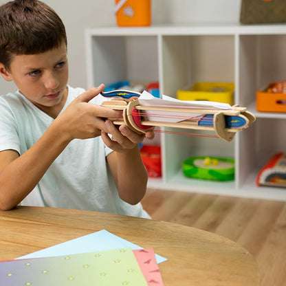 Fat Brain Toys wooden paper airplane launcher engineering kit showing assembly pieces.