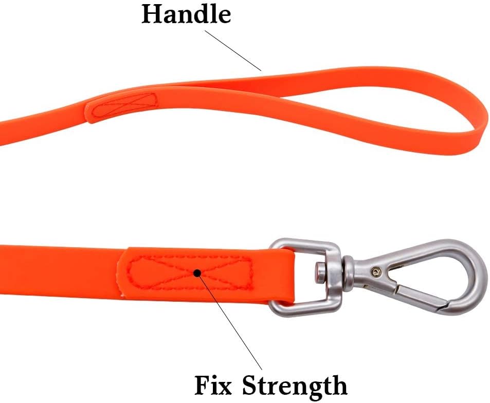 Orange long line dog leash thirty feet length laid out on grass.