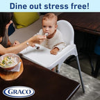 Rolling up a used disposable baby placemat for quick and easy clean up after dinner