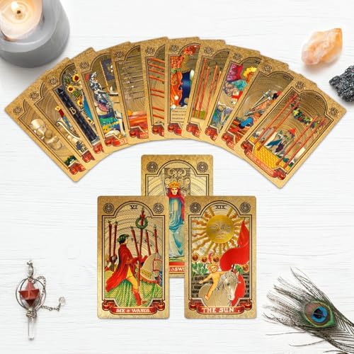 Hand holding a fan of KIINO gold foil tarot cards