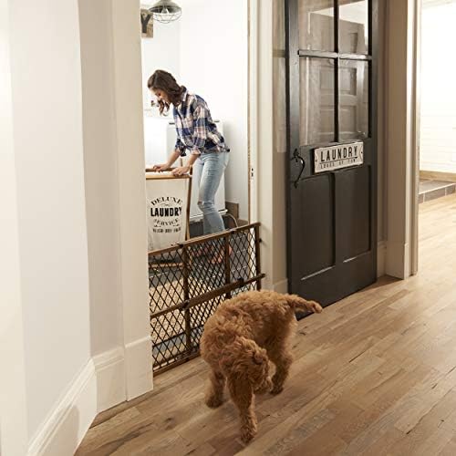 Evenflo Farmhouse Collection wooden baby gate blocking access to a kitchen area.