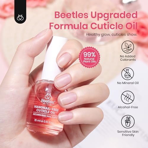Hand applying rose scented cuticle oil to nail beds