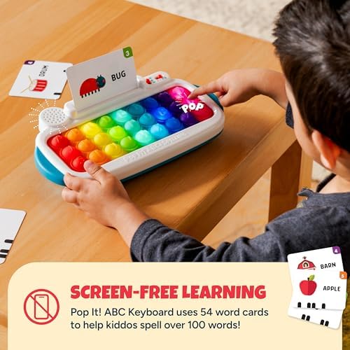 Toddler learning toy keyboard displaying the illuminated LED light-up letters during spelling game mode.