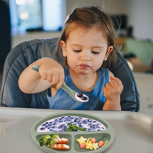 An infant safely gripping the lightweight short handle of the Eascrozn baby-led weaning spoon.