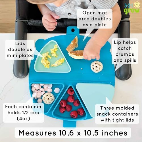 Aqua colored bear shaped toddler plate and silicone placemat laid flat on a restaurant table