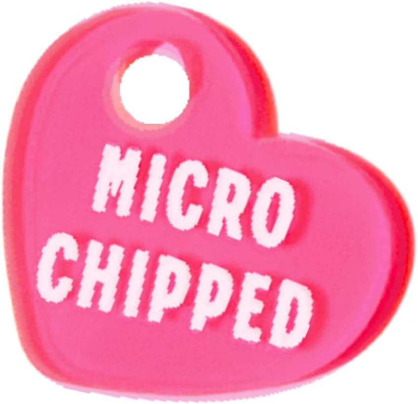 Durable neon pink pet safety tag showing the embossed microchipped text clearly.